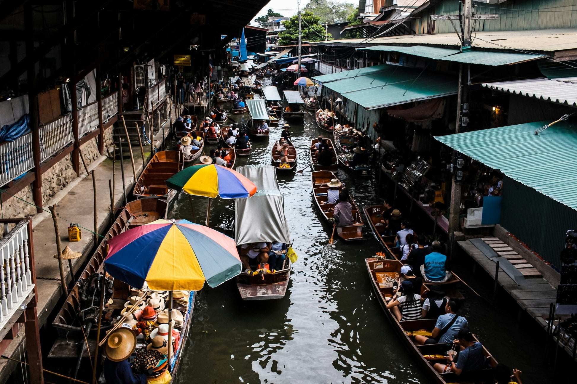 wooden hand made boats pass up and down through the floating market.